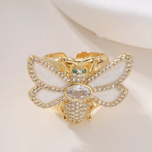 Luxurious 18K gold bee open ring with white enamel wings and sparkling zircons