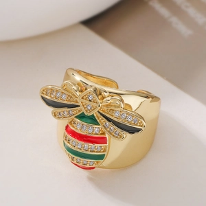 Macro shot of 18K gold plated bee ring with colorful enamel and zircon stones