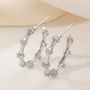 Silver C-shaped bamboo earrings with gold plating and sparkling zircon stones for women