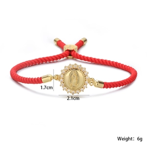 Detailed view of red woven Virgin Mary bracelet with 18K gold plated zircon pendant