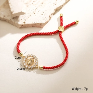 Detail of 18K gold Virgin Mary pendant red string bracelet with white zircon inlay