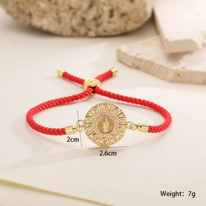 Detail view of 18K gold plated Virgin Mary pendant with cubic zirconia on a red rope