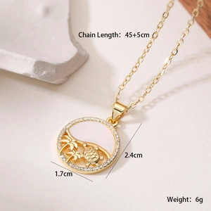 Detailed view of 18K gold sea turtle pendant with dimensions 2.4cm by 1.7cm and zircon