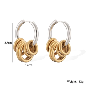 Detail showing 2.7cm stainless steel two-tone hoop earrings with five small gold rings