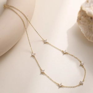 Close-up of 18K gold plated flower necklace with six shimmering zircon floral charms