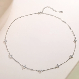Elegant silver-toned necklace featuring seven clover charms inlaid with sparkling cubic zirconia