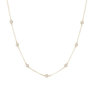 Detail of elegant 18K gold plated necklace featuring seven bezel-set round zircon gemstones