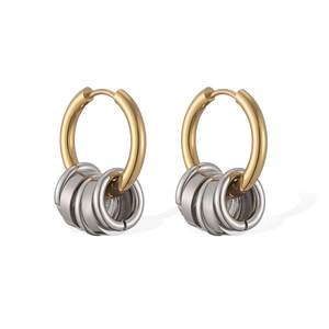 Detailed macro of minimalist two-tone hoop earrings with dangling silver rings