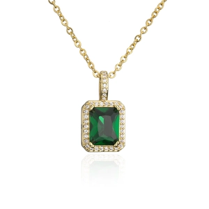 Makroaufnahme von smaragdgrünem Kristallanhänger mit Zirkonia-Halo an goldener Kette