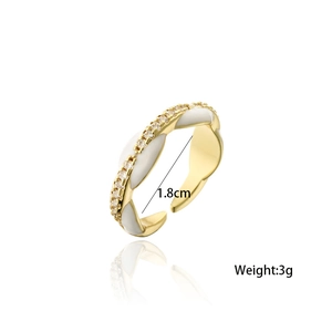 Detail view of 18K gold plated twisted ring with white enamel and sparkling zircons