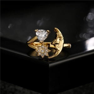 Golden moon and star heart ring with zircon stones on a luxury black display