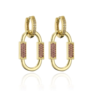 Detailed macro of 18K gold plated hoop earrings with pink zircons and textured metal finish