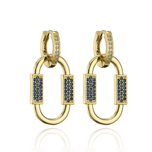 Detail view of 18K gold earrings with blue and white micro-pave crystals on white background