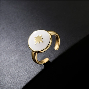 18K gold plated adjustable ring with white enamel disc and gold North Star motif