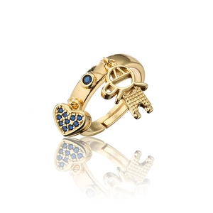 Detail of 18K gold ring with blue zircon heart charm and hollow figure pendant