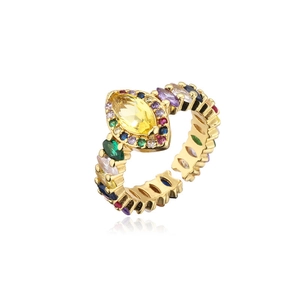Detail of bohemian gold ring with a yellow marquise stone and colorful zircon accents