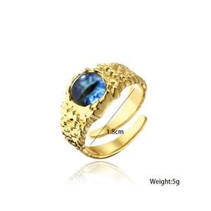 Detailed macro view of 18K gold plated evil eye ring with blue gemstone and scale texture