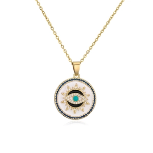 Macro detail of gold plated necklace featuring enamel evil eye pendant with blue crystals