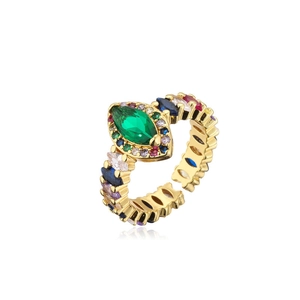 Detail macro view of 18k gold plated ring with colorful crystals and green gemstone