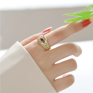 Detail view of 18K gold plated evil eye ring with amber texture and hammered metal band