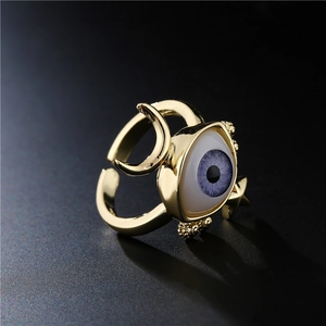 Golden 3D geometric evil eye open ring with purple blue pupil and crescent moon design