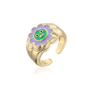 Detail of 18K gold plated sunflower smile face ring with purple and green enamel finish
