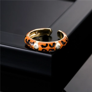 Adjustable gold plated ring featuring orange leopard enamel and sparkling zircon stones