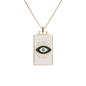 Detail of evil eye rectangular pendant with white enamel and sparkling crystals