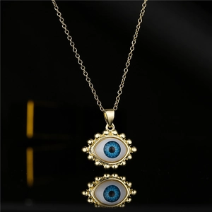 18K gold plated copper evil eye pendant necklace with blue eye detail on black background