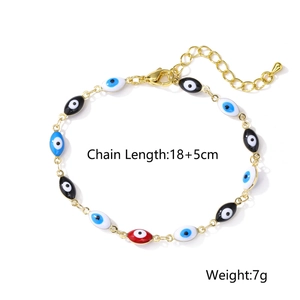 Detail view of gold-plated evil eye beaded bracelet with colorful enamel charms
