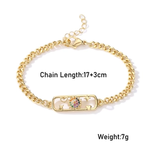 Detail of gold curb chain bracelet featuring a sunburst pendant with zircon and 17+3cm length