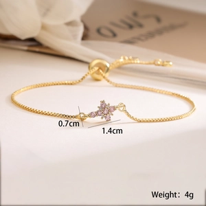 Detailed view of gold cross bracelet with pink zircon flower charms and size dimensions