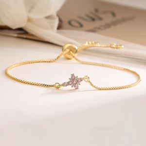 Adjustable 18K gold plated chain bracelet with a delicate pink zircon flower pendant