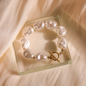 Elegant baroque pearl bracelet with 18K gold plated toggle clasp on beige silk