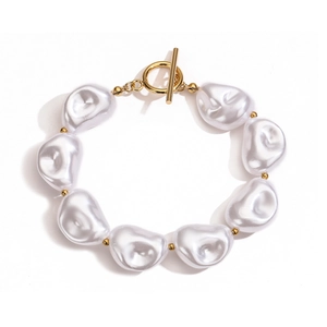 Detailed view of Baroque pearl bracelet with 18K gold plated OT clasp on white background