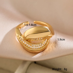 Macro shot of 18K gold plated open ring with zircon inlay on silk background