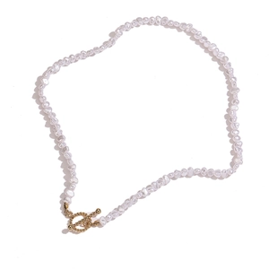 Elegant baroque irregular pearl necklace with a stylish golden OT toggle clasp on white background