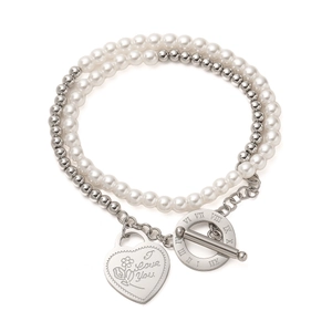 Detail of double-layer bracelet with pearls, heart charm and Roman numeral OT clasp