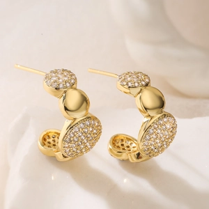 Elegant gold-tone C-shaped hoop earrings with sparkling cubic zirconia and polished beads