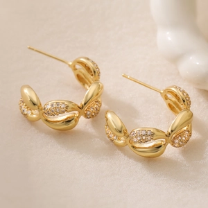 Elegant C-shaped gold hoop earrings with pavé zircon stones and shell-like texture