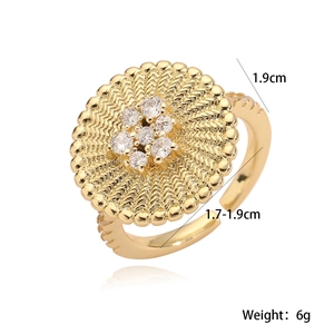 Macro shot of 18K gold plated flower ring with zircons and radial wavy texture details