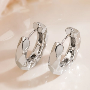 Irregular silver geometric hoop earrings with modern textured crinkle design and metallic finish