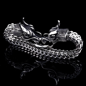 Polished stainless steel double dragon head bracelet with textured wheat chain links