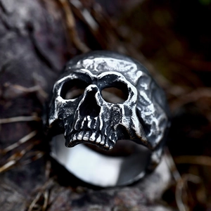 Macro shot of detailed stainless steel skull ring with vintage distressed metal finish