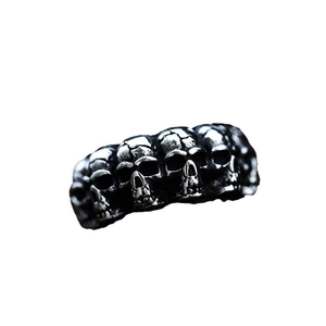 Retro punk style stainless steel ring featuring five detailed silver skull relief carvings