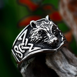 Vintage Viking wolf head ring for men in antique finish stainless steel on wood