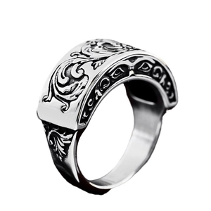 Vintage stainless steel ring with baroque floral relief on white background