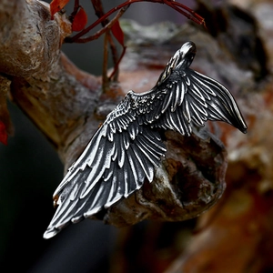 Detailed view of vintage stainless steel angel wing pendant with textured feathers