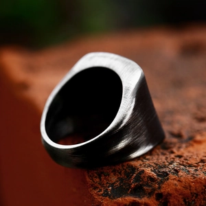 Macro shot of industrial vintage men's ring with brushed dark grey square surface