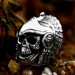 Retro stainless steel skull ring with Indian feather headdress on a stone background
